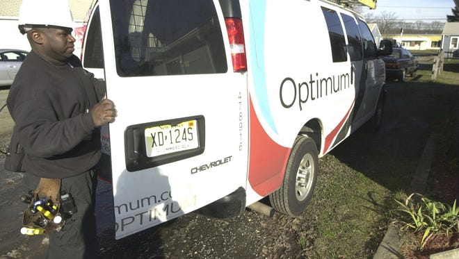 A Cablevision employee works out of his van in Wall in this file photo. Cablevision has been bought out by Altice.