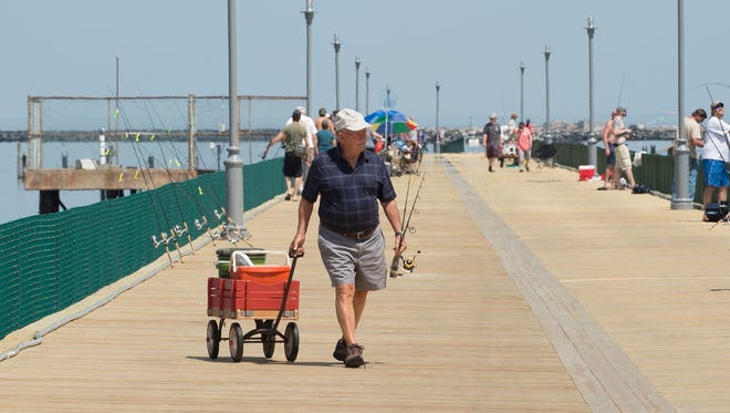 Dr. Art Henry of Lewes pulls his fishing gear down the newly reopened fishing pier at Cape Henlopen State Park in Lewes.