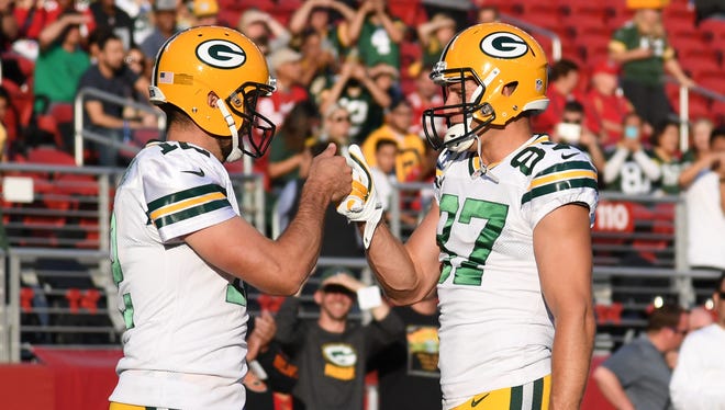 Green Bay Packers quarterback Aaron Rodgers (12) bumps fists with wide receiver Jordy Nelson (87) before the game against the San Francisco 49ers at Levi's Stadium.