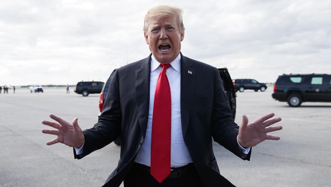 President Donald Trump speaks to media before boarding Air Force One, Sunday, March 24, 2019, at Palm Beach International Airport, in West Palm Beach, Fla., en route to Washington.
