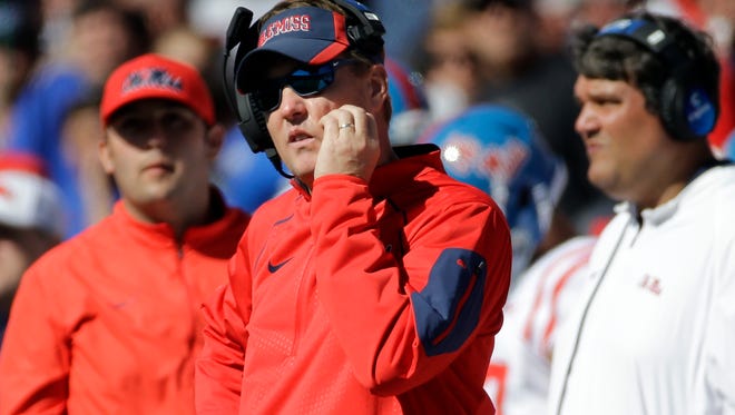 Ole Miss coach Hugh Freeze, center, watches from the sideline as the Rebels lose 37-24 at Memphis on Saturday.