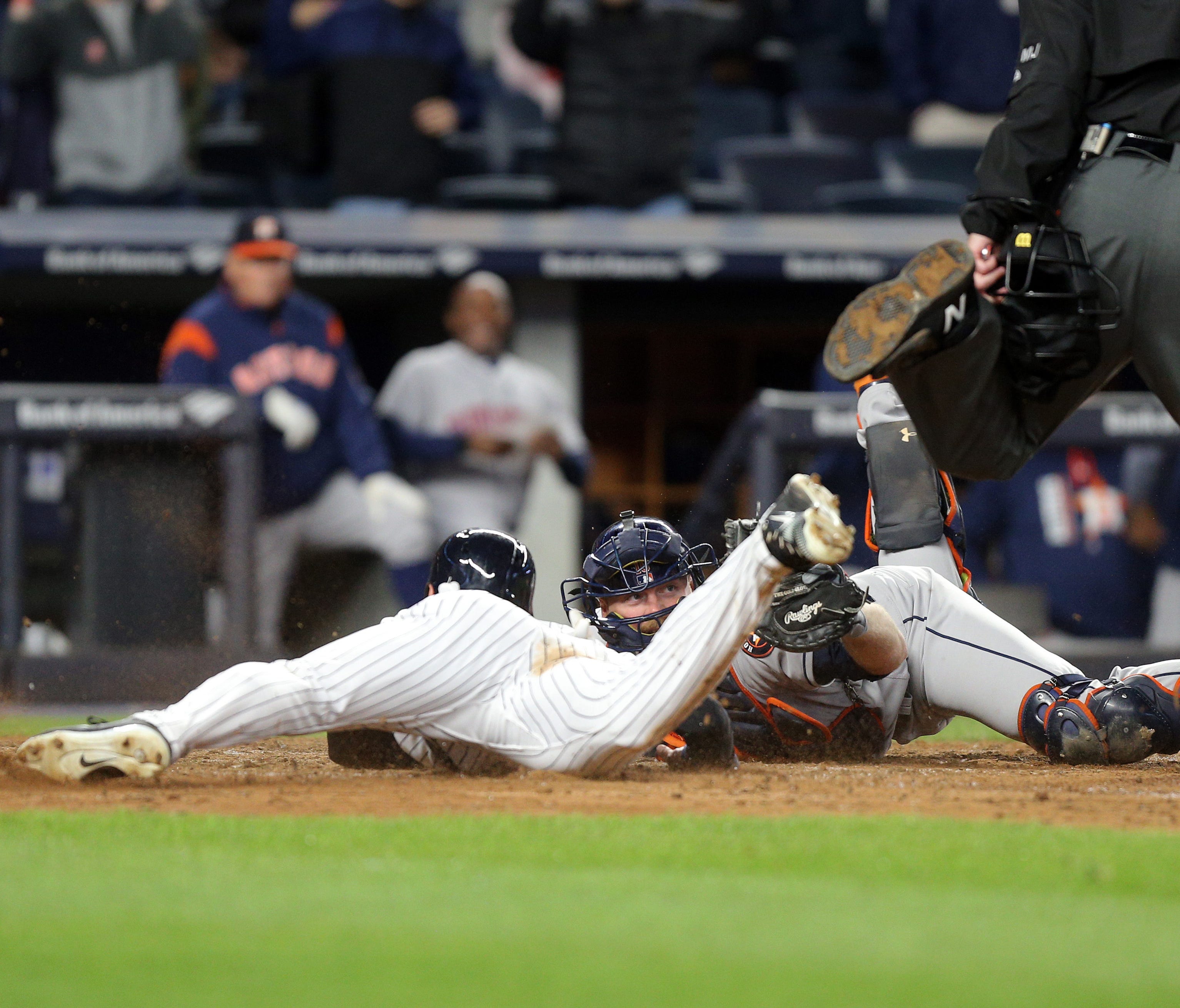 The Yankees' Jacoby Ellsbury, left, is tagged out to end the game by Astros catcher Brian McCann, right, preventing the tying run from scoring at Yankee Stadium.