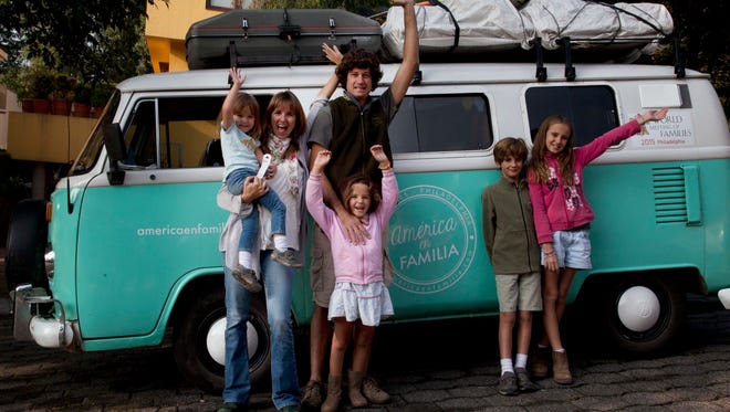 Catire Walker; his wife, Noel; and their four children, Carmin, Mia, Dimas and Cala, pose for a photo in front of their Volkswagen bus in Mexico City on Aug. 22.