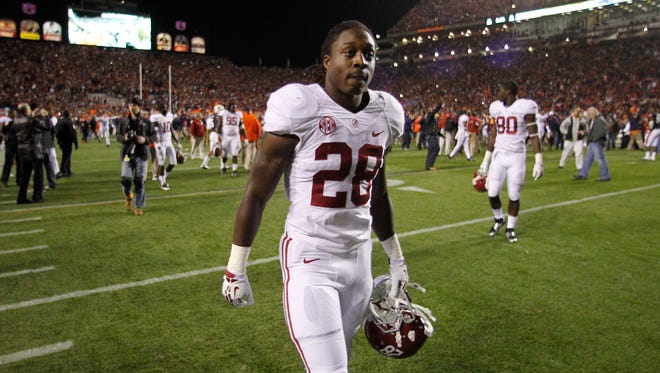 This Nov. 30, 2013, file photo shows then-Alabama running back Altee Tenpenny (28) walking off the field following a loss to Auburn. A coroner says the 20-year-old college football player has been killed in a one-car crash in Mississippi.  Altee Tenpenny was pronounced dead at 6:57 p.m. Tuesday, Oct. 20, 2015, at Delta Regional Medical Center in Greenville. Washington County Coroner Methel Johnson says Tenpenny was taken to the hospital after he wrecked a 2008 Dodge Charger near the community of Glen Allan.