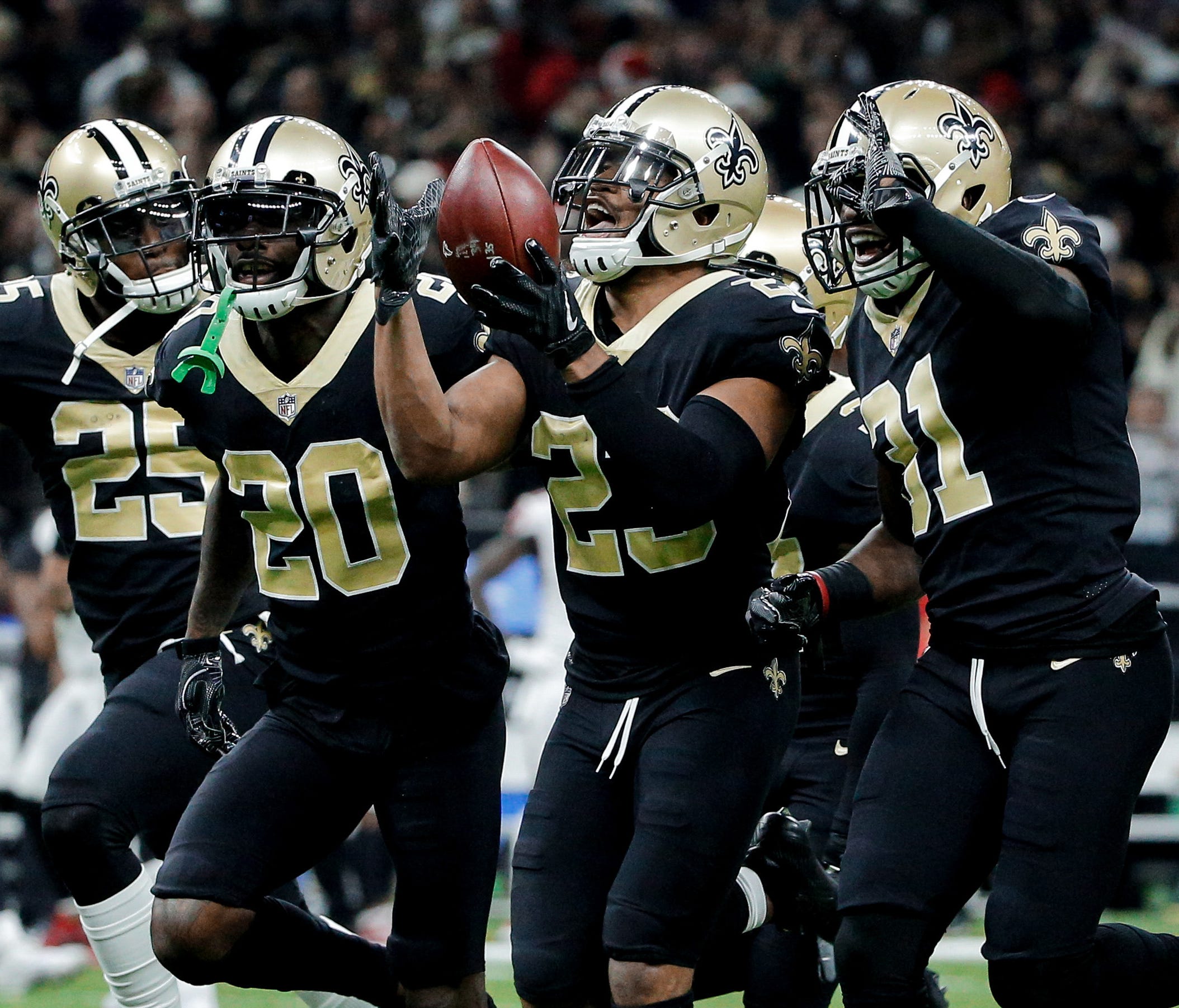 New Orleans Saints cornerback Marshon Lattimore (23) celebrates with teammates after a interception against the Atlanta Falcons during the second quarter at the Mercedes-Benz Superdome.