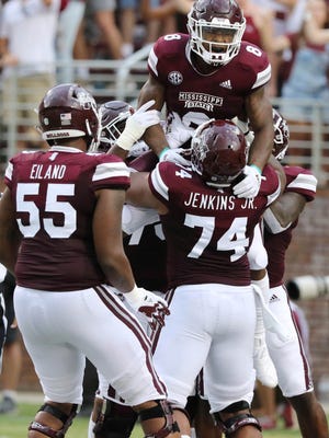 Mississippi State running back Kylin Hill (8) celebrates his 53-yard touchdown pass reception against Stephen F. Austin during the first half of their NCAA college football game on Saturday, Sept. 1, 2018, in Starkville, Miss. (AP Photo/Jim Lyle)