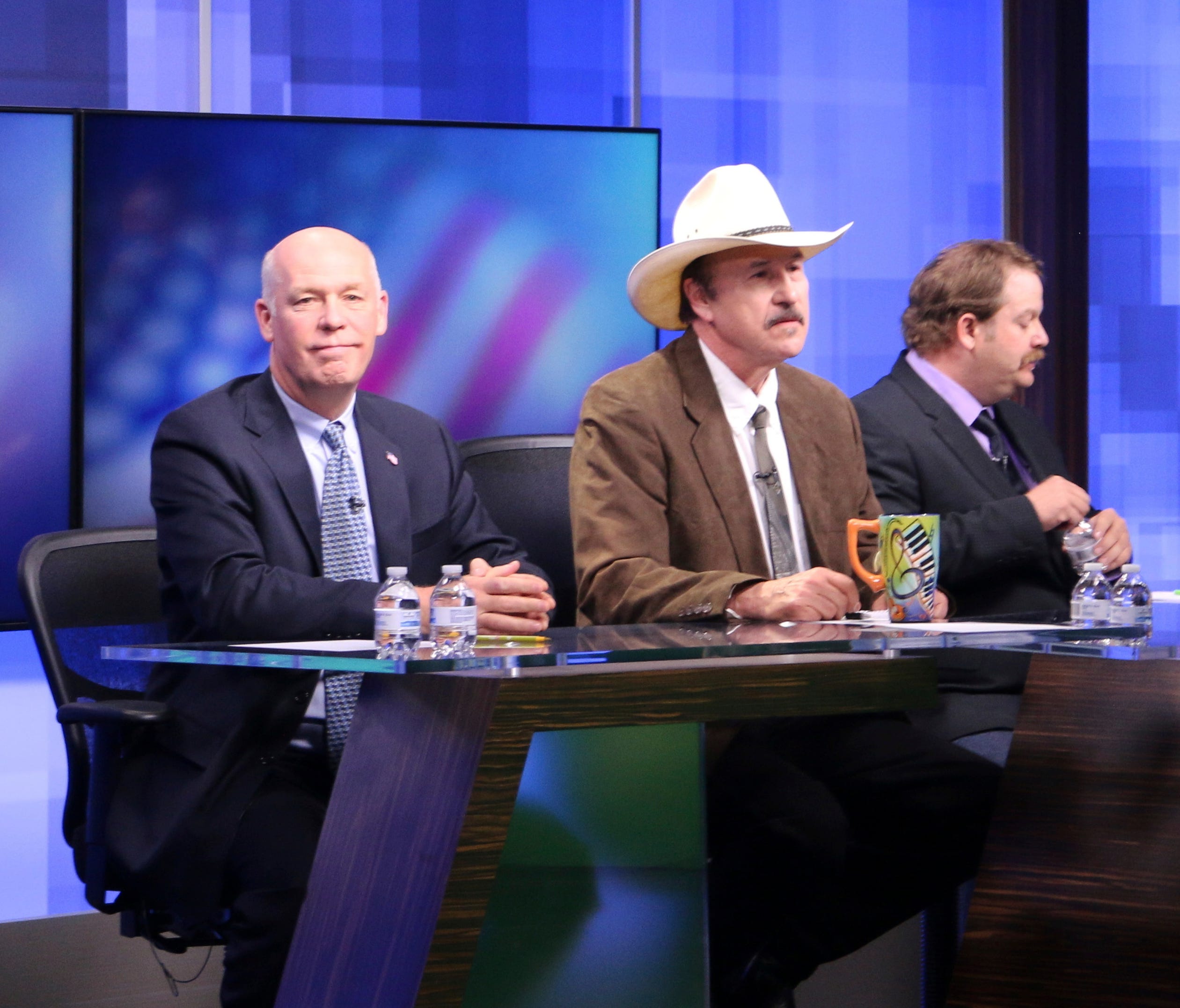 The three candidates, Republican Greg Gianforte, from left, Democrat Rob Quist and Libertarian Mark Wicks vying to fill Montana's only congressional seat await the start of the only televised debate ahead of the May 25 special election, on April 29, 