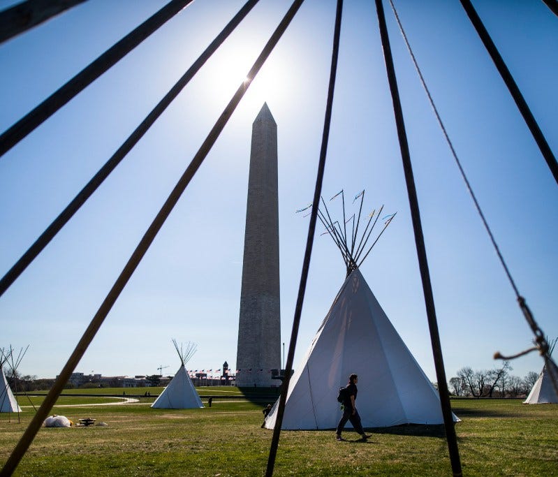 Indigenous protesters built seven tipis on the National Mall near the White House on Tuesday.