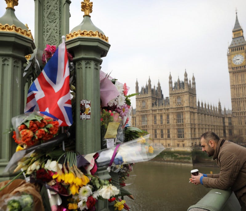 Flowers are left on Westminster Bridge by the Houses of Parliament in memory of those who died in last week's terror attack.