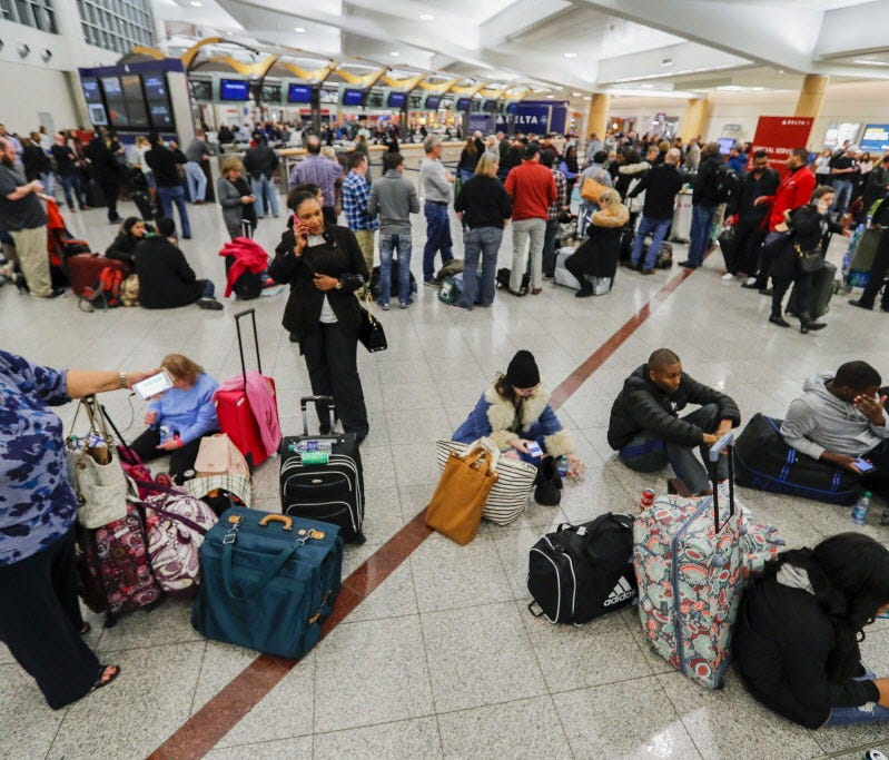 Stranded Delta Air Lines passengers wait to check in at the main terminal at Hartsfield-Jackson Atlanta International Airport after a technology outage on Jan. 29, 2017.