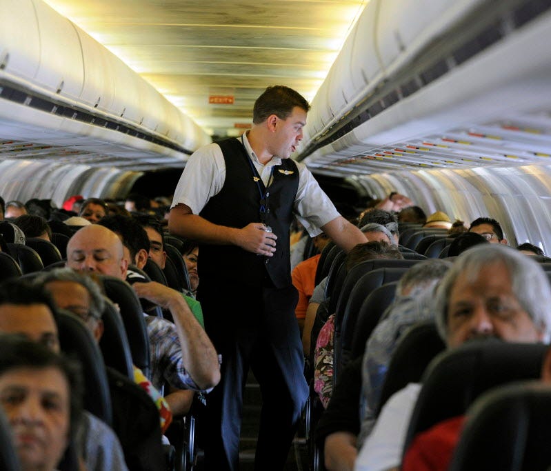 Allegiant Air flight attendant Chris Killian prepares passengers for a flight May 9, 2013, before it pushes back from the terminal at McCarran International Airport in Las Vegas. The Federal Aviation Administration announced April 19, 2017, that 44 p