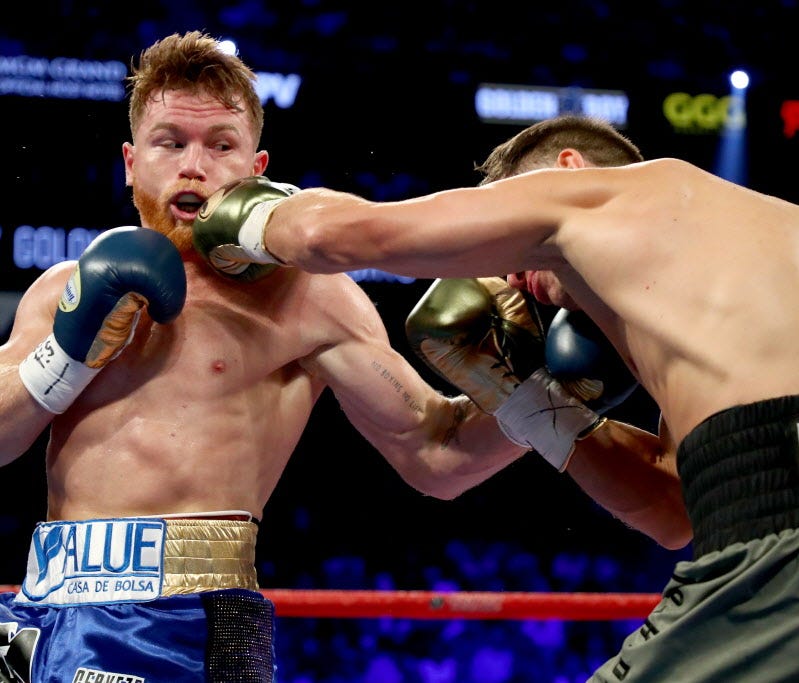 Canelo Alvarez, left, and Gennady Golovkin exchange blows during their WBC, WBA and IBF middleweight championship bout at T-Mobile Arena in Las Vegas on Saturday.
