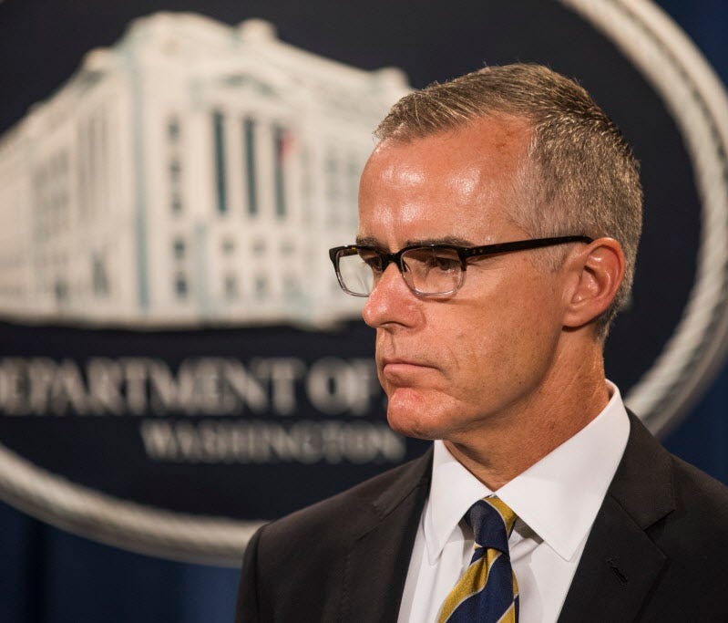 Then-acting FBI director Andrew McCabe waits to speak at a press conference to announce the results from the Justice Department's annual national health care fraud takedown at the Department of Justice in Washington, D.C., July 13, 2017.