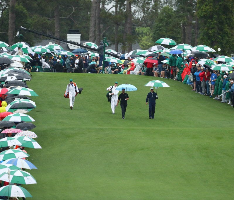 Jeff Knox (right) and Paul Casey walk off the first tee during the third round of the Masters at Augusta National.