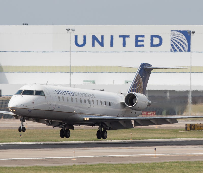 A United Express CRJ-200 lands at Denver International Airport in May 2017.