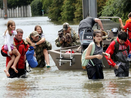 Residents are rescued from their homes surrounded by