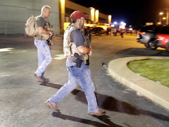 Heavily armed civilians with a group known as the Oath Keepers arrive in Ferguson, Mo., Aug. 11, 2015.