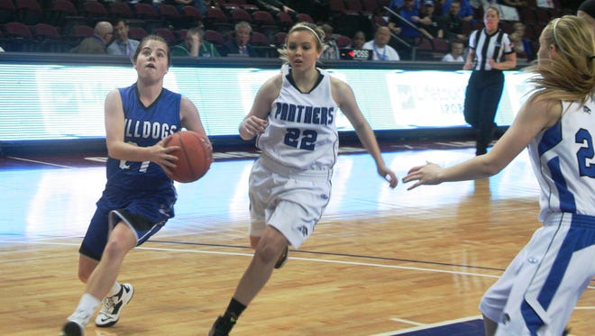 Smith Valley’s Kelly O’Keefe drives to the basket, guarded by Pahranagat Valley’s Karley Whipple during the Division IV state championship game Saturday at the Orleans Arena in Las Vegas.