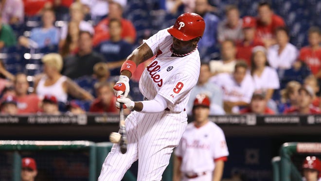 Philadelphia Phillies left fielder Domonic Brown (9) hits an RBI double during the ninth inning Tuesday against the Seattle Mariners at Citizens Bank Park. The Mariners won 5-2. Credit: Bill Streicher-USA TODAY Sports