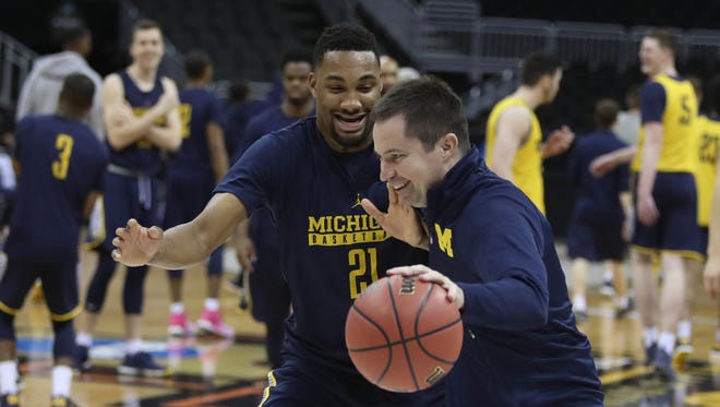 Michigan wing Zak Irvin goes one-on-one with assistant coach Billy Donlon, right, after practice at the NCAA Midwest Regional on Wednesday, March 22, 2017, at the Sprint Center in Kansas City, Mo.