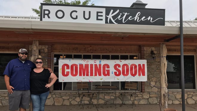 Jason and Brandie Bomer, owners of Rogue Kitchen, stand outside the site of their new restaurant on July 31, 2018.