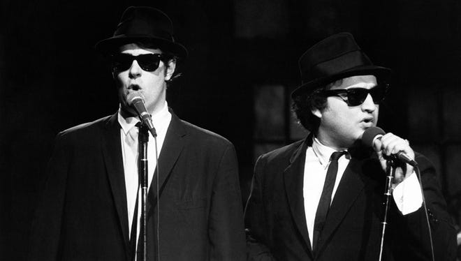 This Nov. 18, 1978 photo released by NBC shows Dan Aykroyd as Elwood Blues, left, and John Belushi as Jake Blues, performing as the Blues Brothers on "Saturday Night Live," in New York. The long-running sketch comedy series will celebrate their 40th anniversary with a 3-hour special airing Sunday at 8 p.m. EST on NBC. (AP Photo/NBC, Al Levine)