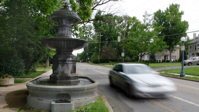 Traffic on Clifton Avenue came uncomfortably close to the Probasco Fountain in Clifton in this 2013 picture. The fountain has been taken down and will be moved to a safer spot less than 10 feet from its original location. ,