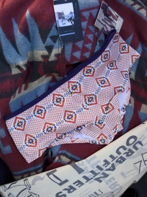 Purchased items from Urban Outfitters’ Navajo line are shown in Tempe, Ariz., on Oct. 14, 2011. The Navajo Nation is suing Urban Outfitters months after the tribe sent a cease and desist letter to the clothing retailer demanding it pull the “Navajo” name from its products. The lawsuit filed late Tuesday in federal court in New Mexico alleges trademark infringements and violations of the federal Indian Arts and Crafts Act.