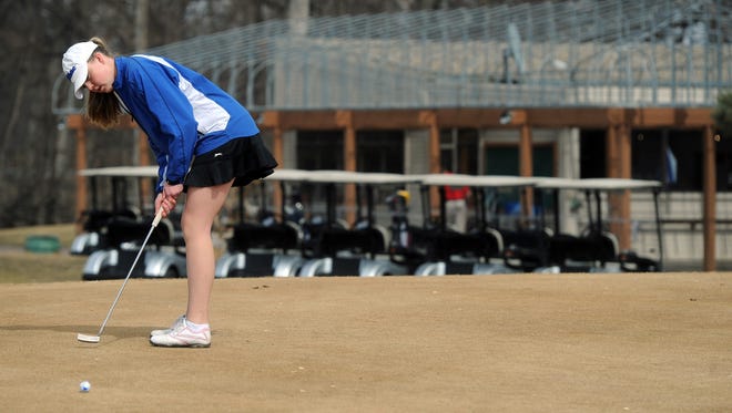 Emily Olson putts on the green while golfing March 30 at Westward Ho Country Club.