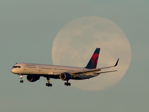 A Delta Air Lines Boeing 757 passes in front of a rising