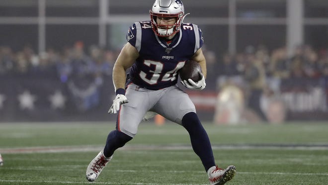 The Patriots and running back Rex Burkhead, shown carrying the ball in New England's playoff loss to the Titans, recently agreed to a restructured deal to the final year of his contract to help free up some more cap space for the team heading into the 2020 season.