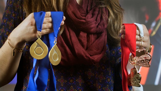 U.S. Olympian Summer Britcher, of Glen Rock, holds two gold medals, left, won in Park City, Utah, as well as a bronze and gold medal, right, from Calgary, Canada. The Susquehannock High School graduate leads the World Cup overall standings in women's singles at the midpoint of the 2015-16 season.
