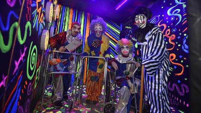 Volunteers Austin Falish, from left, Georgia Englebert, Lydiah LeCloux and Gracie Englebert depict wildly, crazed clowns inside the Haunted Mansion.