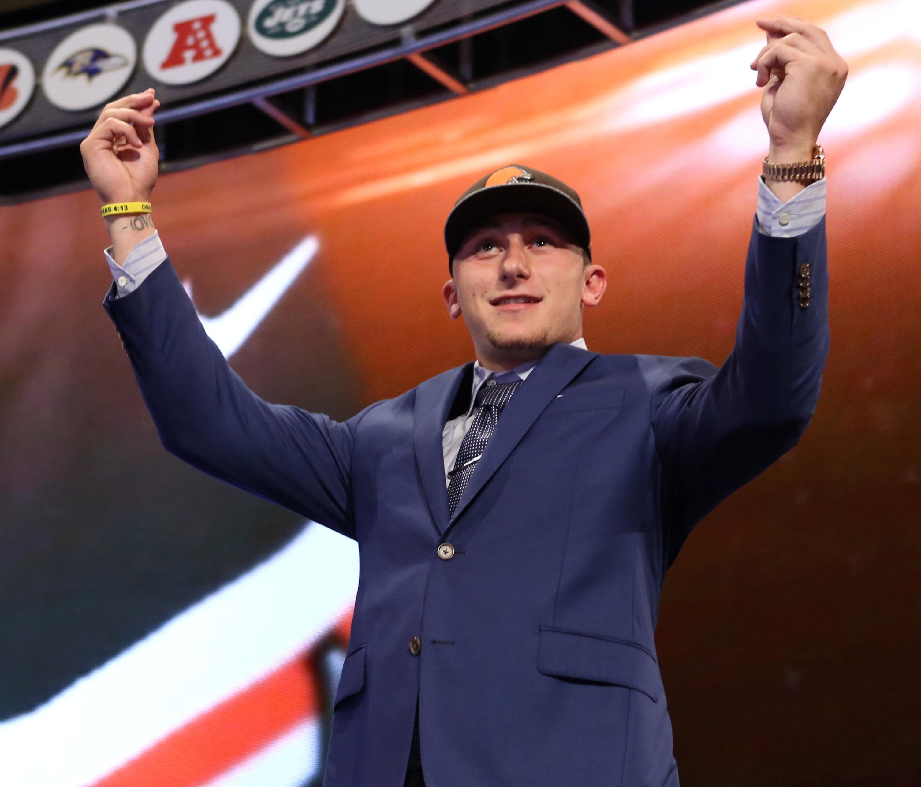 Johnny Manziel gestures on stage after being selected as the No. 22 overall pick in the first round of the 2014 NFL Draft.