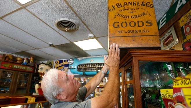 Don Johnson, owner of Don Johnson's Tobacco World on Glenstone Avenue, shows off one of the may antiques he has in his shop on Monday, Oct. 3, 2016. Johnson appeared on the History Channel's American Picker show.