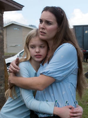 Northpointe resident Valerie Shimmin, right, consoles her daughter, Jaden, after the theft of two family pets. In the day's following last week's tornado, a suspected looter broke into the Shimmin home and made off with two rabbits and other items belonging the family.