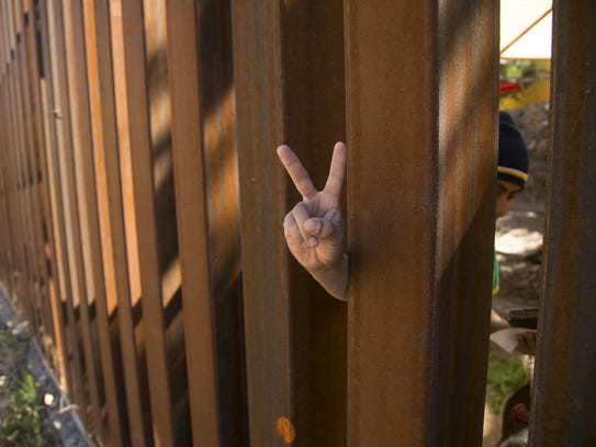 Freddy Perez, 26, flashes a peace sign through the
