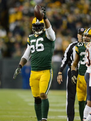 Green Bay Packers Julius Peppers (56) celebrates his sack and fumble recovery after a sack of Jay Cutler against the Chicago Bears.