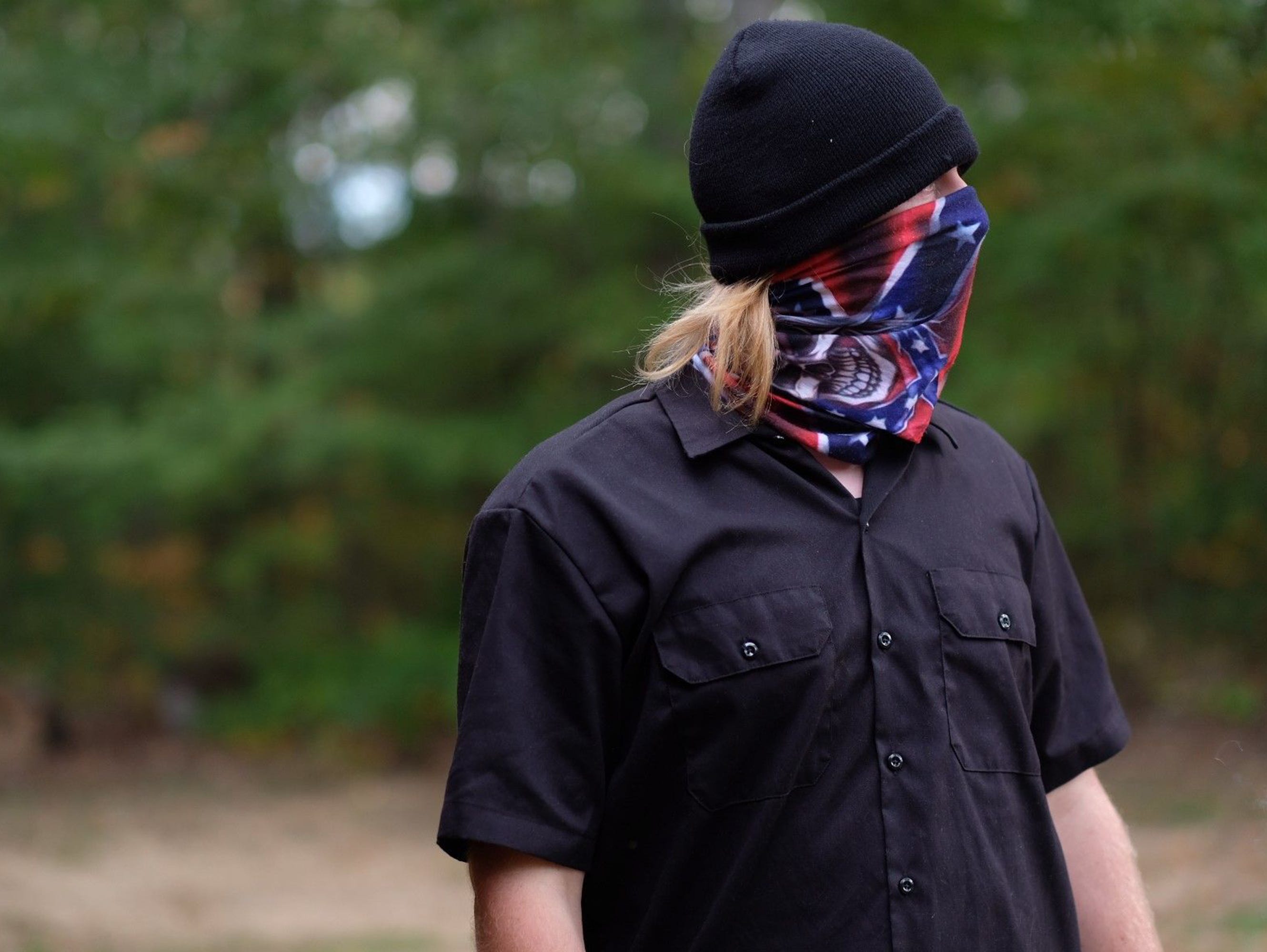A young white supremacist at the Stormfront summit Sept. 30, 2017, in Crossville, Tenn., decided to wear a cap and bandana so his picture wouldn't be recognizable on social media.