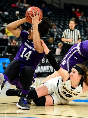 Northwestern forward Pallas Kunaiyi-Akpanah (14) tries to pass the ball against Iowa forward Megan Gustafson.