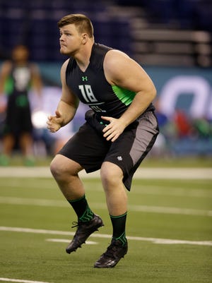 Graham Glasgow runs a drill at the NFL combine last month.