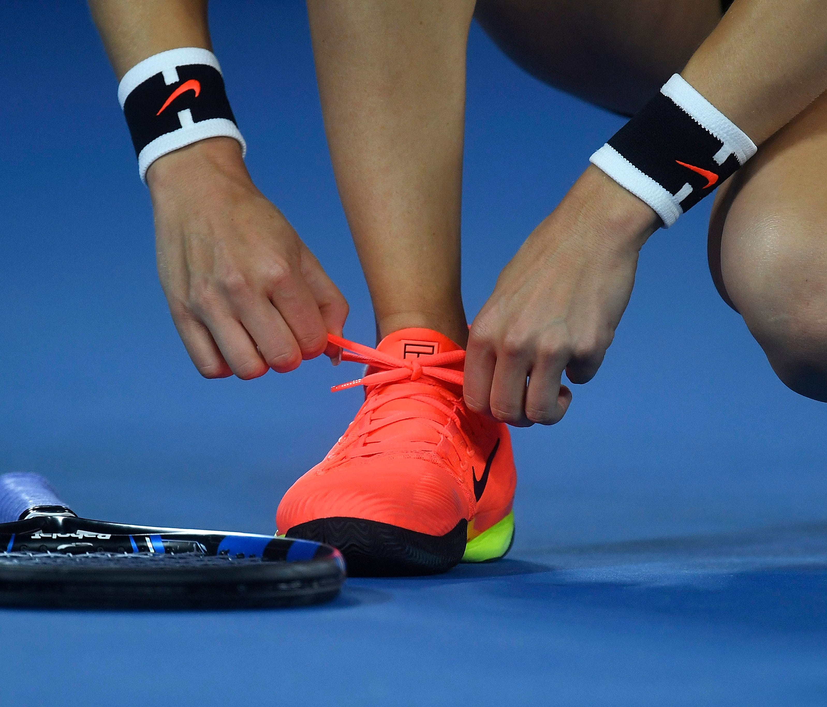Eugenie Bouchard of Canada ties her shoes during her match against Coco Vandeweghe of the USA in round three of the Women's Singles at the Australian Open Grand Slam tennis tournament in Melbourne, Victoria, Australia, on Jan. 20, 2017.