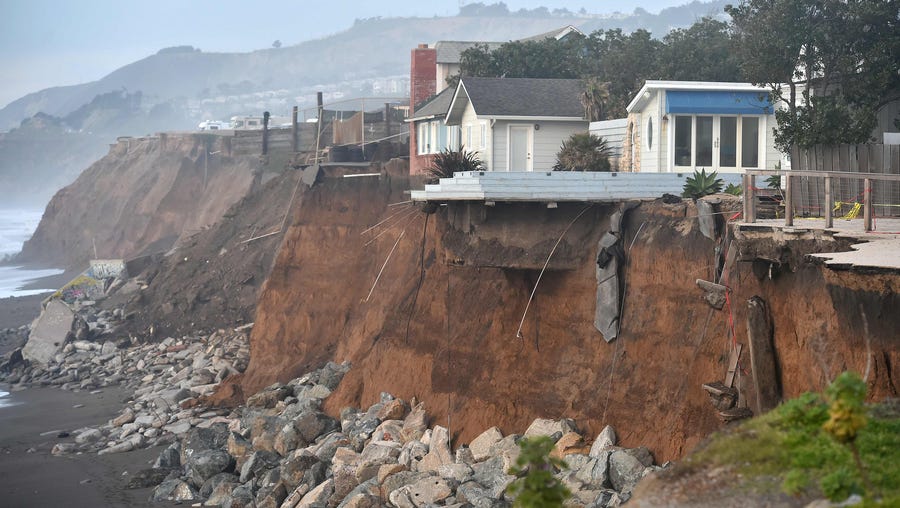 Sections of land are seen missing from coastal properties in Pacifica, Calif., on Jan. 26, 2016. Storms and powerful waves caused by El Niño have been intensifying erosion along nearby coastal bluffs and beaches in the area.