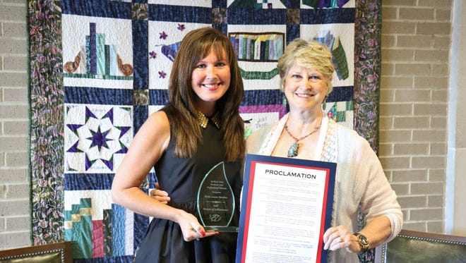Kristi Seaton Turnbow, left, and Jackie Utley pose together Monday at the Jackson-Madison County Library. Turnbow was named the Jackson Business & Professional Women's "Woman of Achievement."