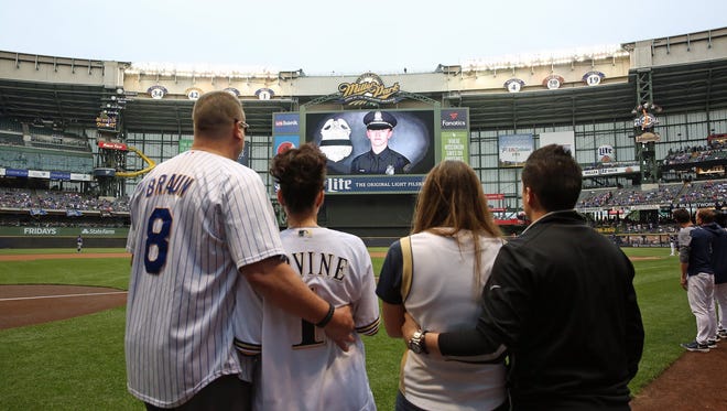 The Milwaukee Brewers began their game Monday with a moment of silence and presented a team jersey to the mother and family of Officer Charles Irvine, 23, who died in the line of duty on Thursday.