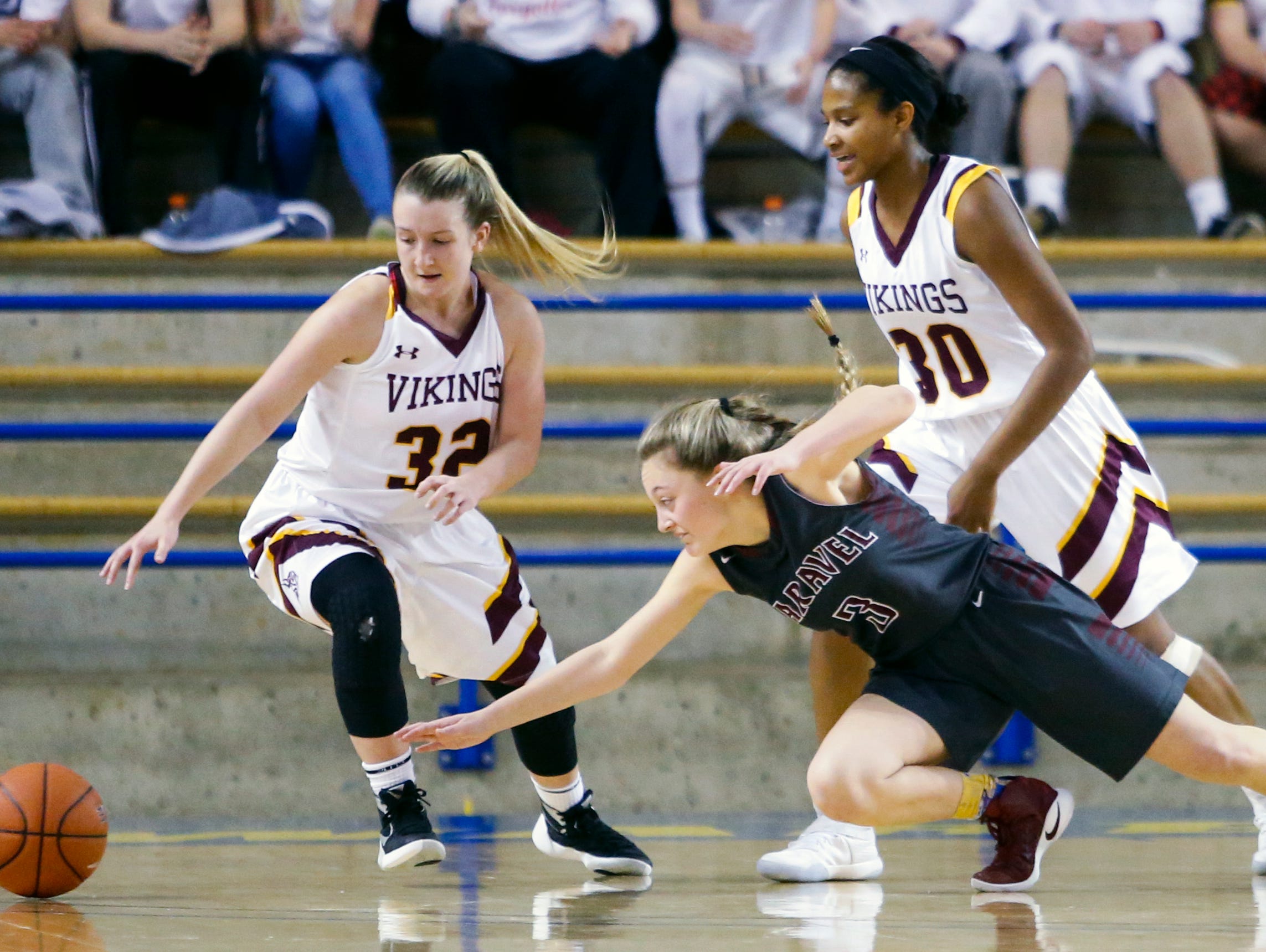 Caravel's Karli Cauley (3) moves for a loose ball between St. Elizabeth's Alexis Bromwell (left) and Alanna Speaks in the second half of Caravel's win in a DIAA state tournament semifinal Wednesday at the Bob Carpenter Center.