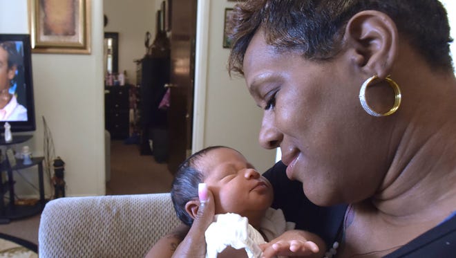 Kim Simmons, 48, of Center Line, holds her 11-day-old daughter, Jai-Marie Woodson, Friday, July 27, 2018. Simmons is a juvenile lifer who was freed last year after 29 years in prison. She never got to raise her first daughter and views the birth of Jai-Marie as a second chance at motherhood.