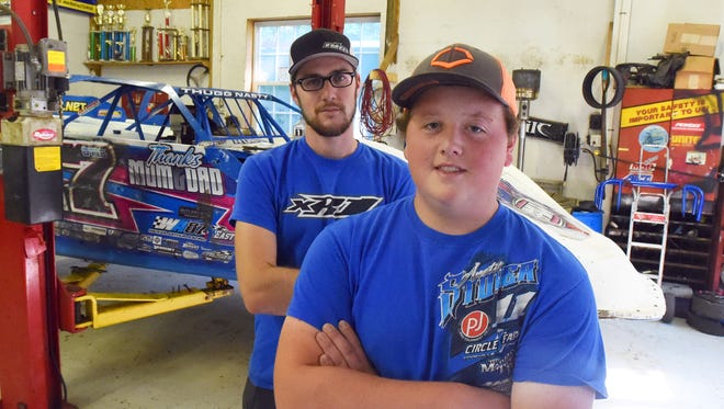Logan Roberson is photographed with Team manager and crew chief Trevor Cash behind him in a shop in Waynesboro on Wednesday, July 19, 2017. Together, they stand near the Rocket XR1 race car Roberson races.  Roberson has been racing since he was 16.
