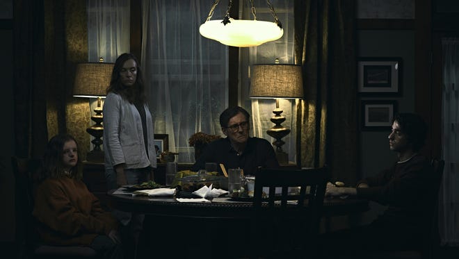 Charlie (Milly Shapiro, left), Annie (Toni Collette), Steve (Gabriel Byrne) and Peter Graham (Alex Wolff) fall under a family curse in 'Hereditary.'