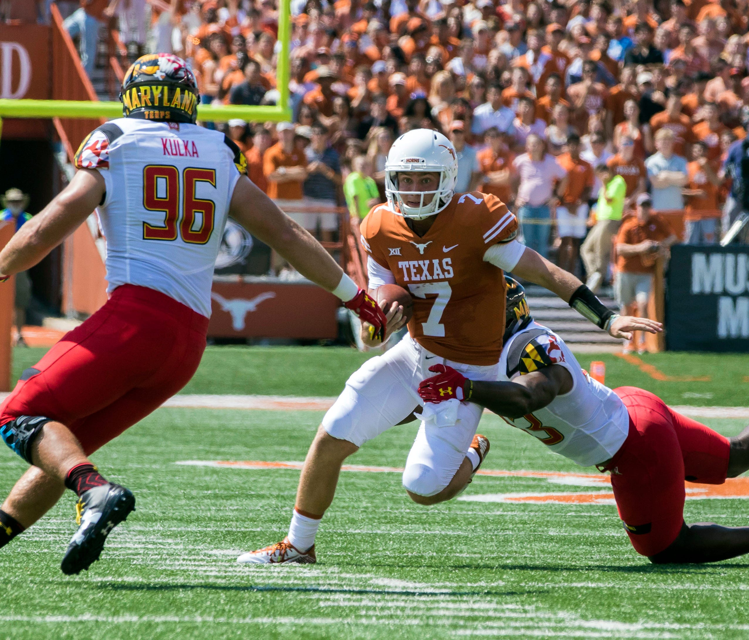 Texas Longhorns quarterback Shane Buechele looks for room to run.
